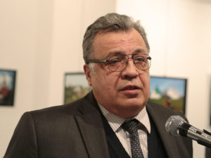The Russian Ambassador to Turkey Andrei Karlov speaks a gallery in Ankara Monday Dec. 19, 2016. A gunman opened fire on Russia's ambassador to Turkey Karlov at a photo exhibition on Monday. The Russian foreign ministry spokeswoman said he was hospitalized with a gunshot wound. (AP Photo/Burhan Ozbilici)
